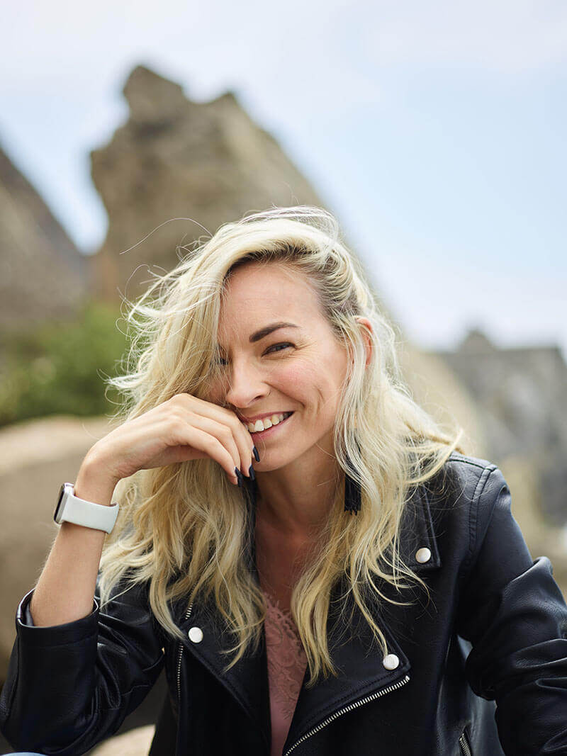 Woman in Leather Jacket Smiles at Camera